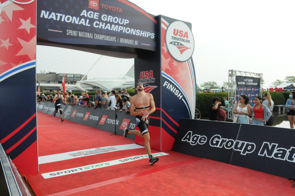 crossing the finish line at sprint triathlon nationals