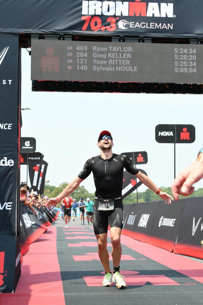 Crossing the Eagleman finish line with the timing board in the background