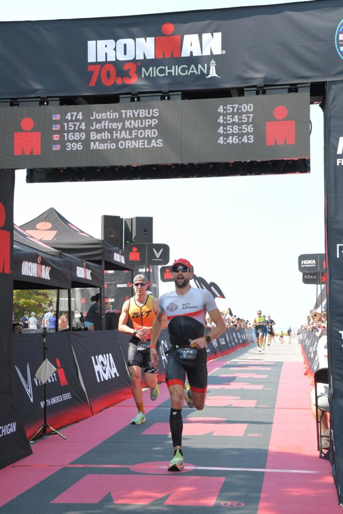 Coach Ryan crossing the finish line at IRONMAN 70.3 MIchigan